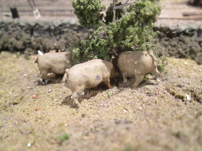 And don't forget livestock. Here are a few pigs rooting under a small tree... what for? Your fields and surrounding land give clues