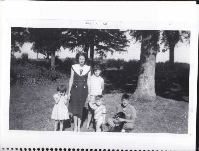 Picture taken in 1958 on the front lawn of our property. Holding a dog, I am pictured with my mother, oldest sister, Beatrice, sister Pat, and toddler brother Philip.
