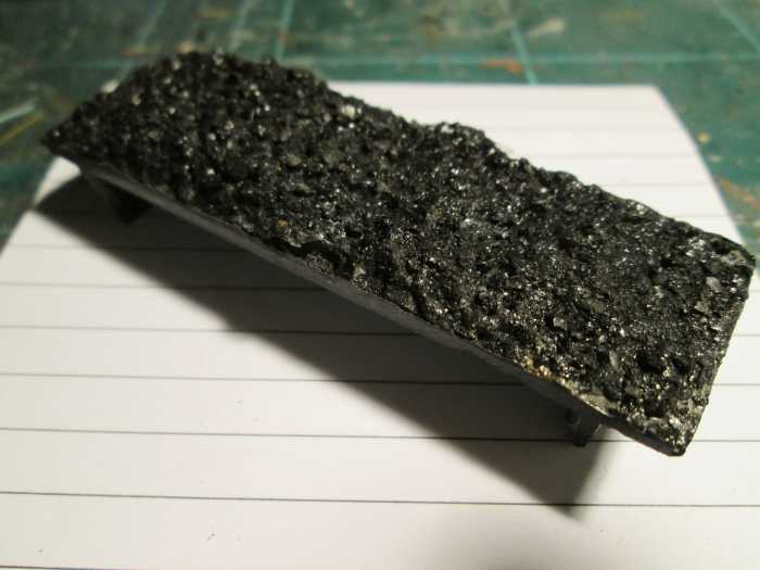 The coal load that comes with the model from the retailer is fairly innocuous. I add real coal on a layer of white pva glue that dries invisibly