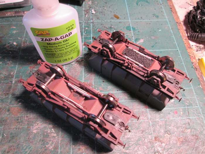 Turn the wagon over, add thin plastic card either side of the hopper mouldings, inside and out, to ensure the lead shot stays within the moulded hoppers when it's poured. Some may overshoot and can be returned to the bag when the superglue dries hard