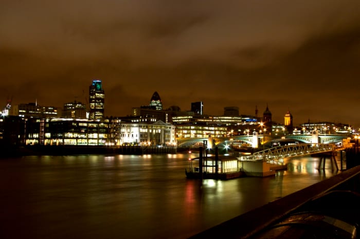 A picture of the River Thames at night as it flows through the English capital, London. The River Thames is the longest river completely in England.