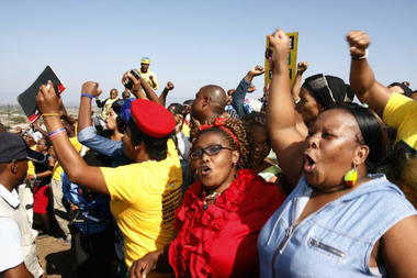 Women wave as South African president and leader of the African National Congress (ANC), Jacob Zuma, arrives to cast his vote in Ntolwane, rural KwaZulu Natal province, South Africa, Wednesday May, 7, 2014. The country goes to the polls in the fifth