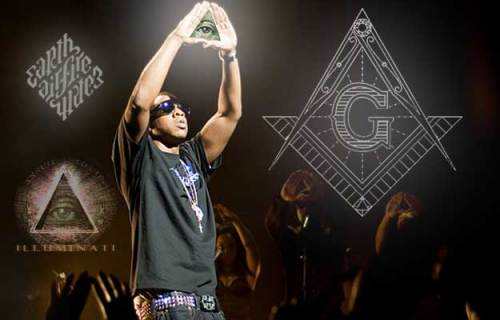 Rapper JayZ makes a Masonic Illuminati pyramid sign during a live performance. Inset, the Mason's symbol