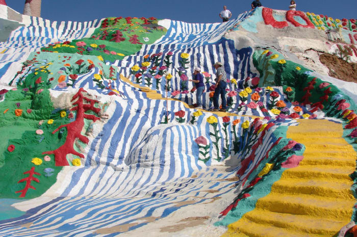 View of the Mountain with the yellow brick road. Size of mountain is put into perspective when you see how tiny the people who climb it look.
