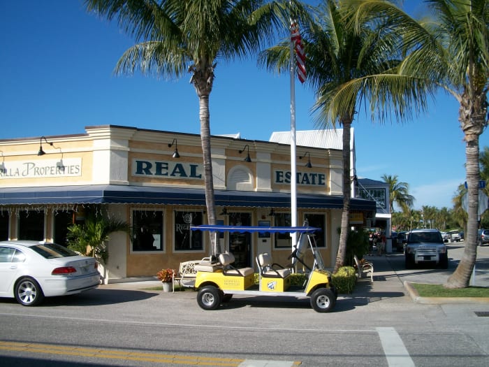 Another storefront. Note the golf cart -- many here eschew cars and use golf carts for everyday travel. Visitors can rent them.