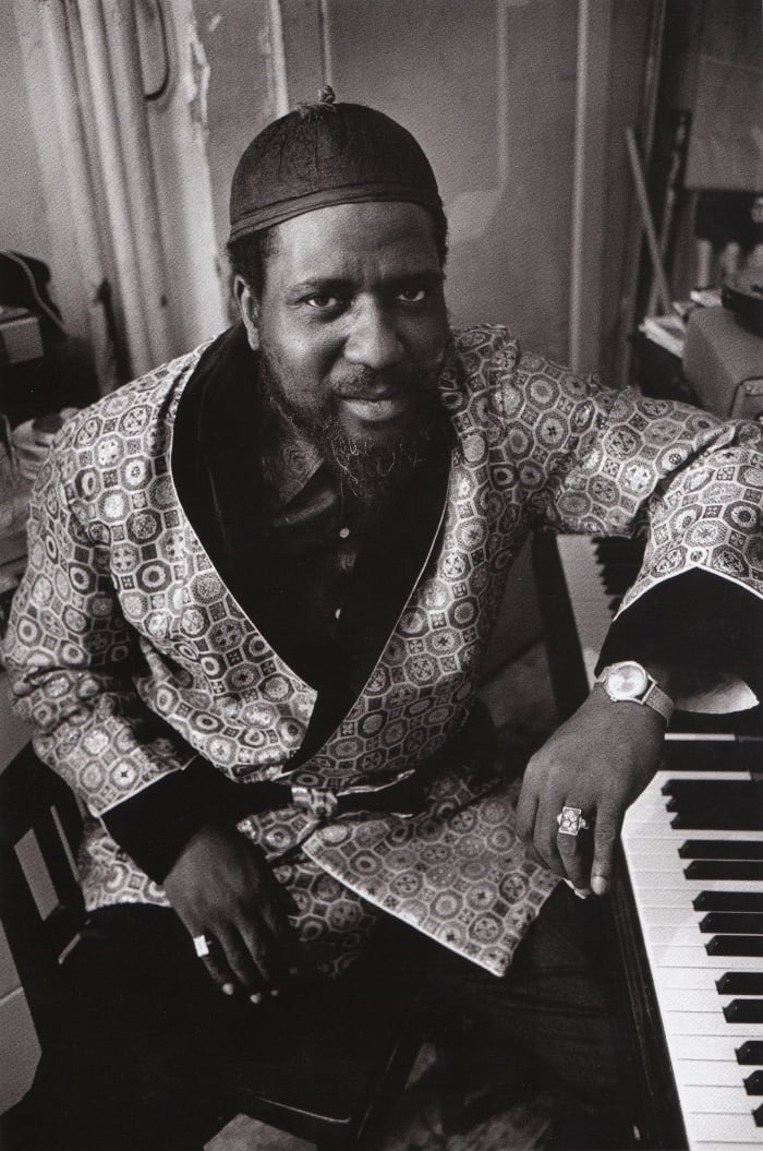 Monk photographed for a Saturday Evening Post Feature in 1963, and Monk is sitting next to his piano dressed in a silk robe.