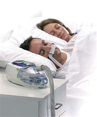 Sleep Apnea Machine shown with man and woman sleeping