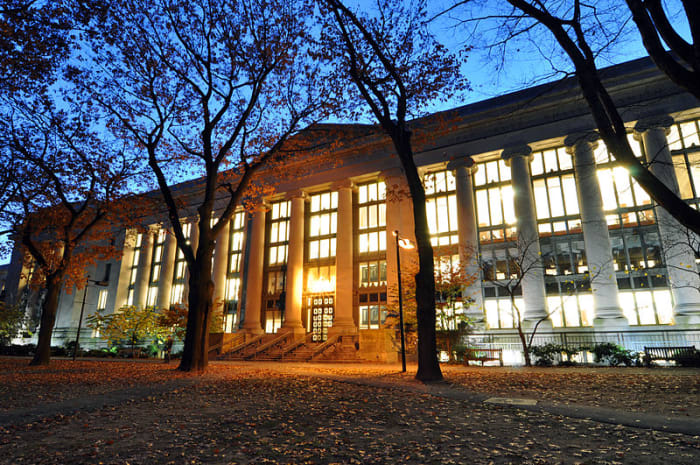 Harvard Law Library at night. This library is a focal point on campus and the largest academic library in the world.