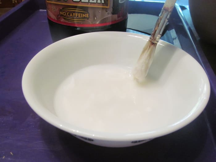 Mix your paste. I use 3/4 bottle of washable children's glue and 1/4 c. of water. Mix with a thicker paint brush that we'll use for the project.
