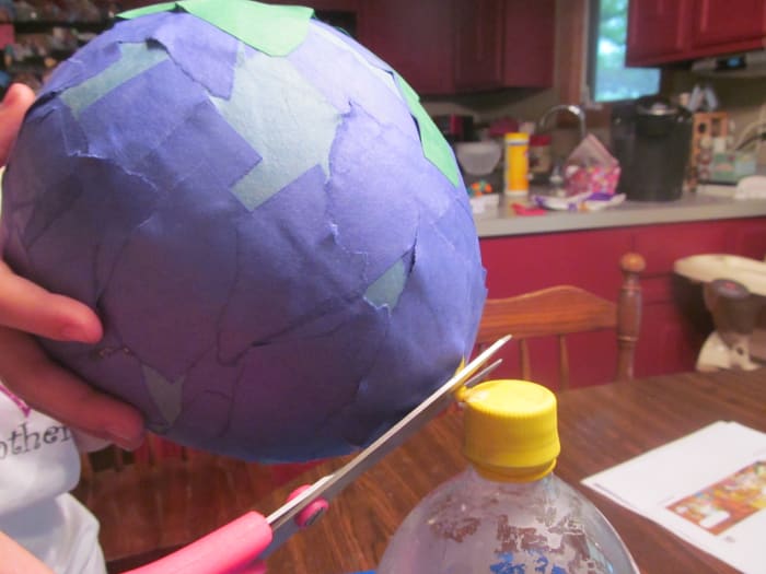 Let your project dry overnight and then cut the bottom of the balloon the next day. It makes a really cool sound as it pulls away from the paper and then you're left with a globe shaped paper project.