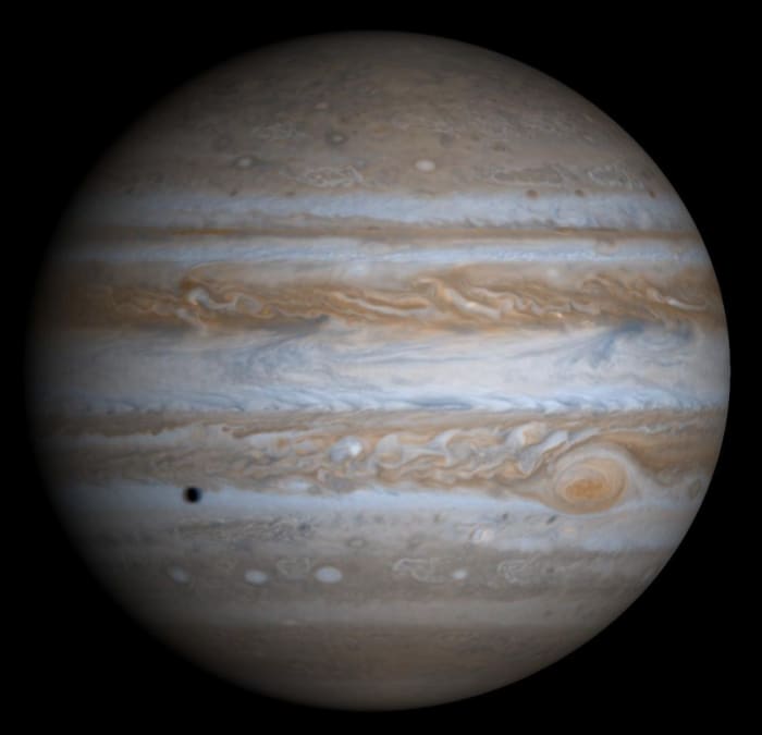 The largest planet in our solar system. You can see the shadow of Europa in the bottom left. Jupiter is one order of magnitude smaller than the Sun, and one order of magnitude larger than Earth.