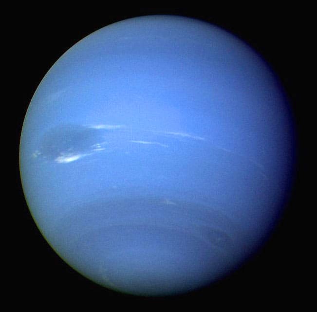Neptune is the most distant planet from the Sun. Visible is the Great Dark Spot - a massive storm similar to that seen on Jupiter.