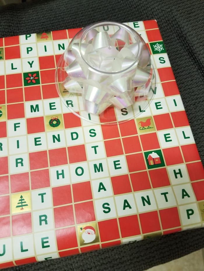 No need to fasten down the cup covering the bow. Just put plenty of crumpled newspaper or padding around so it doesn't shift during shipment. The bow will arrive in perfect condition.