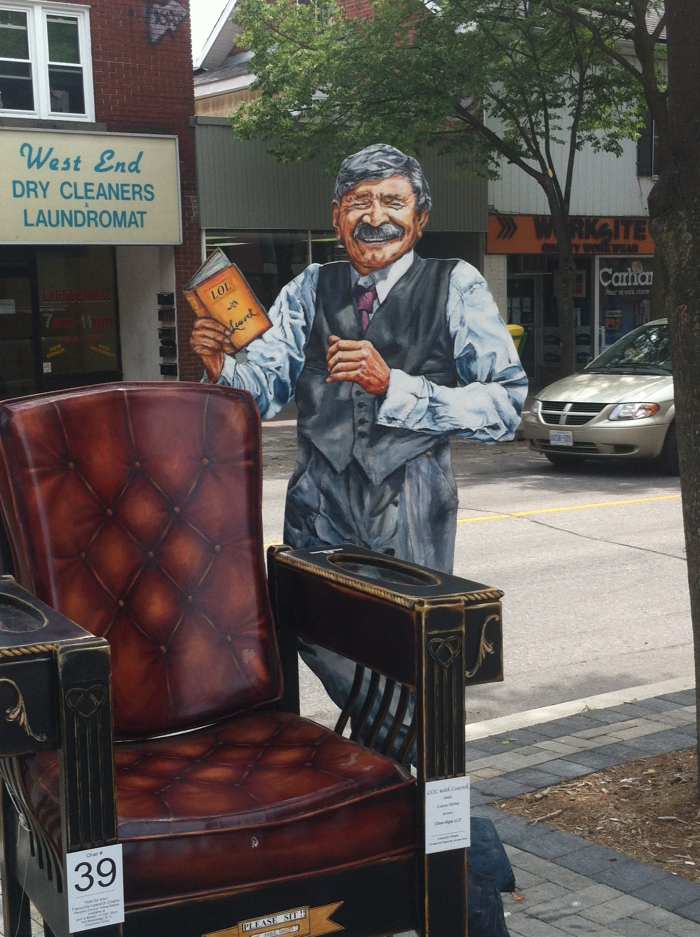 One of several chairs made to look like Stephen Leacock himself. This one he is reading from perhaps one of his own books.