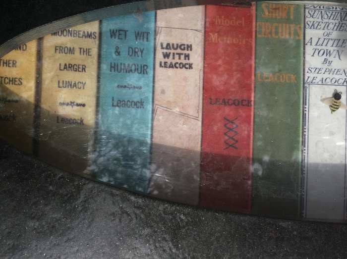 On the armrests of each chair there are cubby holes to hold and display items. From the chair above are books by Stephen Leacock.