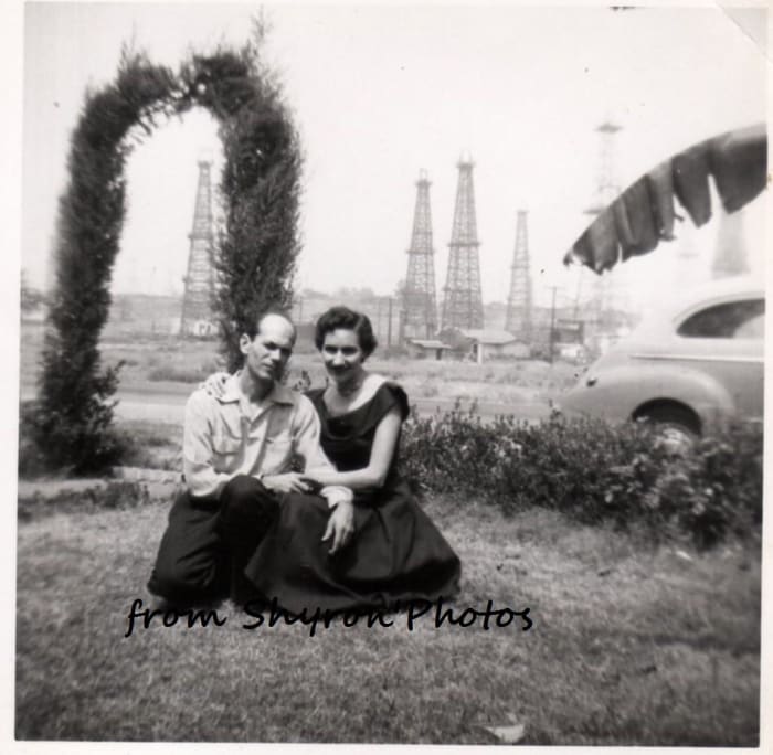 Dad and Mom the day after we moved into the house in California. You can see the oil wells where we found the pigeon.