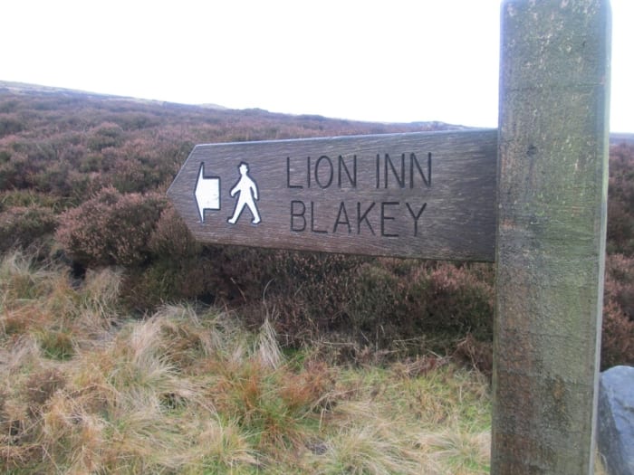 Waymarker to the Lion Inn, a welcome sight for long distance walkers - including Coast-to-Coasters and Lyke Wakers