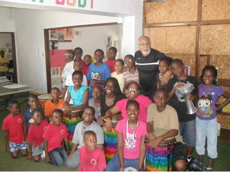 Students New Mirawood Academy pose with Willie after a lesson from his Rhythm of Africa Music Program, which aims to create positive behavioral and cognitive impact through the children’s exposure to and intimacy with learning and making music.