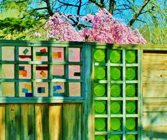 Wooden fencing inset with Blenko glass slabs screens off a small outdoor area that's accessible to visitors through the factory gift shop.
