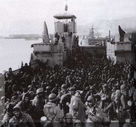 They made it: Marines huddle inside an LST after coming off the plateau. Look carefully at those faces, they capture every human emotion from elation to despair.