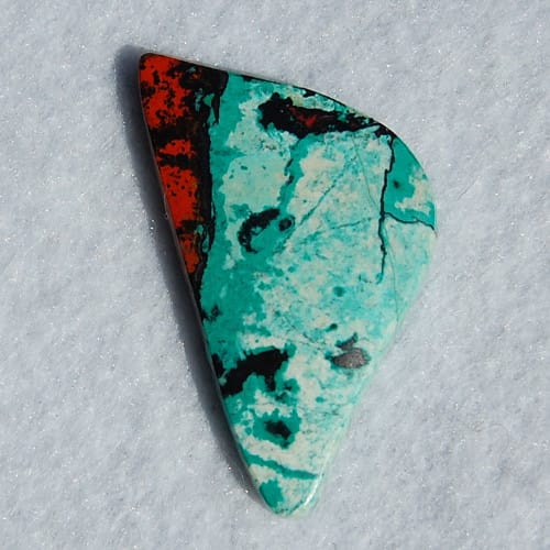 Sonoran Sunrise Chrysocolla cut by Marty Andersen. This unique variety of gemstone gets it's color from Chrysocolla (blue), Cuprite (red) and Tenorite (black).