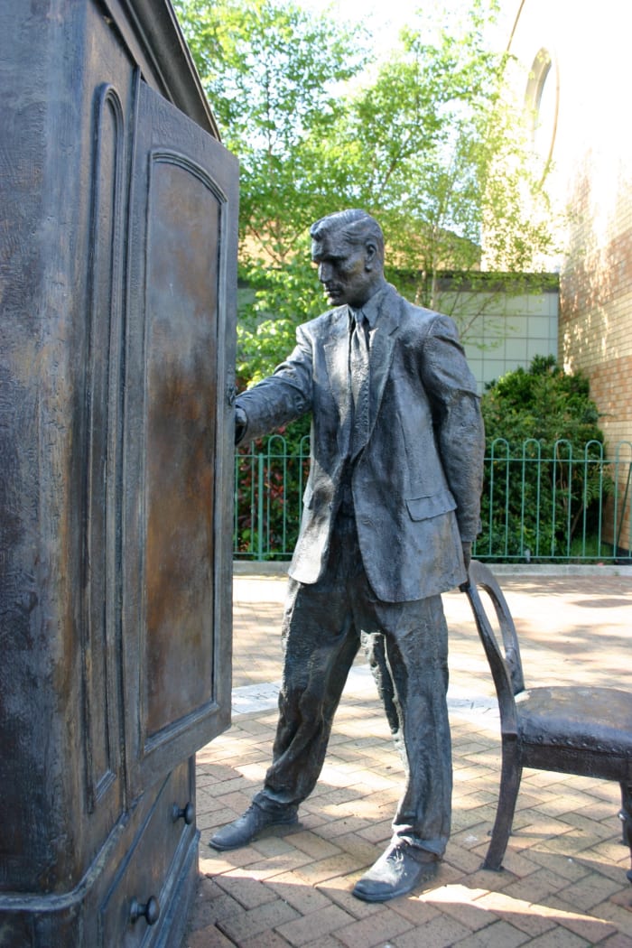 Statue of C.S. Lewis looking into a wardrobe. Entitled "The Searcher," by Ross Wilson. It stands in Belfast, Ireland where Lewis was born.