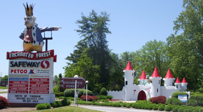 Old King Cole Guards the entrance to what is now a shopping center.