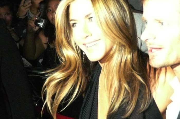 Aniston while she is surrounded by a crush of fans and press.