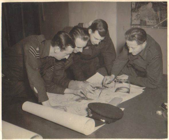 Photo: Taken at Leconfield, Yorkshire, England, probably during the latter part of 1943. Debriefing - L to R; unknown, Ron Last, Les Anderson, Geoff Coombes (crew 50).