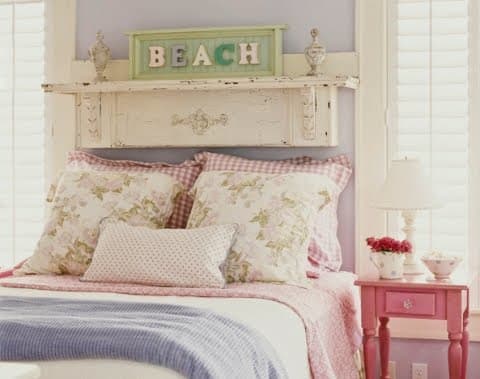 mini-shelf or plate rail above a bed holding a country cottage chic plate for coastal charm - labelled beach