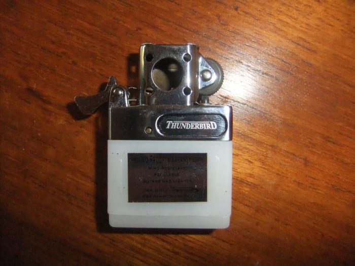 Cam Lever (on left of lighter) down, as it would be when the lid is open, releasing the butane for use