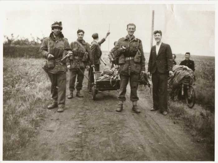 US Paratroopers pose for a snapshot by the road to Arnhem with Dutch civilians