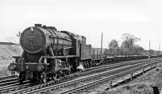 War Department (Riddles' Austerity) Engine 2-8-0 90434 heads Down empty plate wagons for Teesside onto the Low Level lines near Boroughbridge Gates Junction