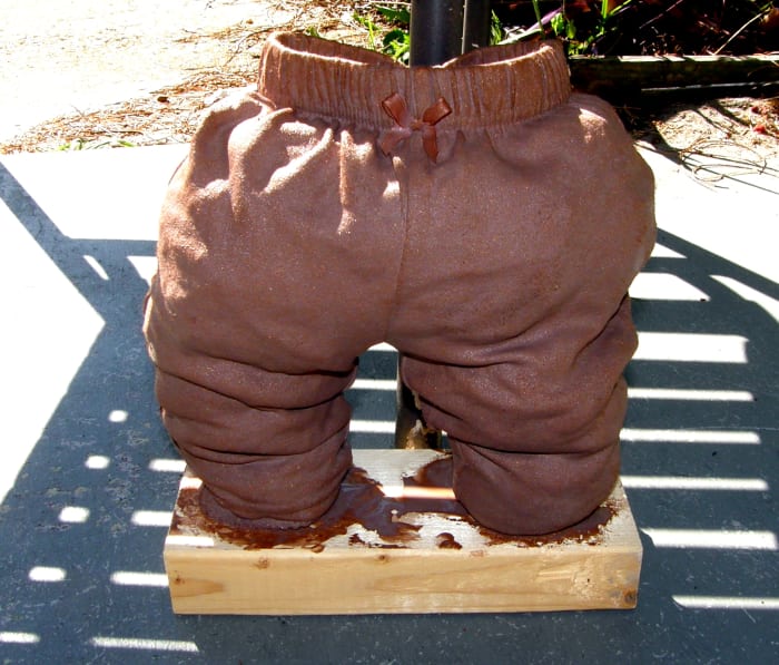 I have placed the sculpture in the sun for faster drying. It is leaning up against a chair for support while it dries. The plastic bags inside create the look and feel of the wrinkles while it dries, plus supports the item.
