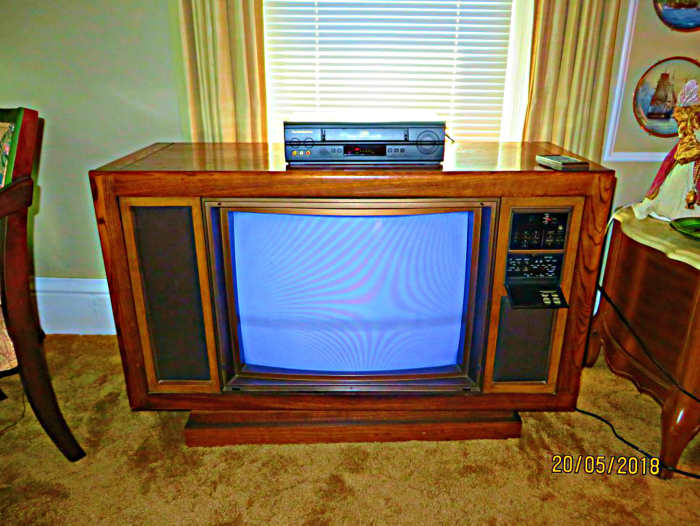 The 1985 Curtis Mathes Color Console, Model K2658RL. This beauty came in genuine Oak Veneer with a swivel base. she also had a removable glass screen.