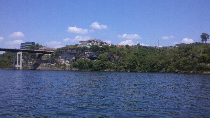 Boat-view of the bluffs where the winery is located. The large white building is JB Hooks, a popular restaurant. The winery is to the right but unable to be seen.