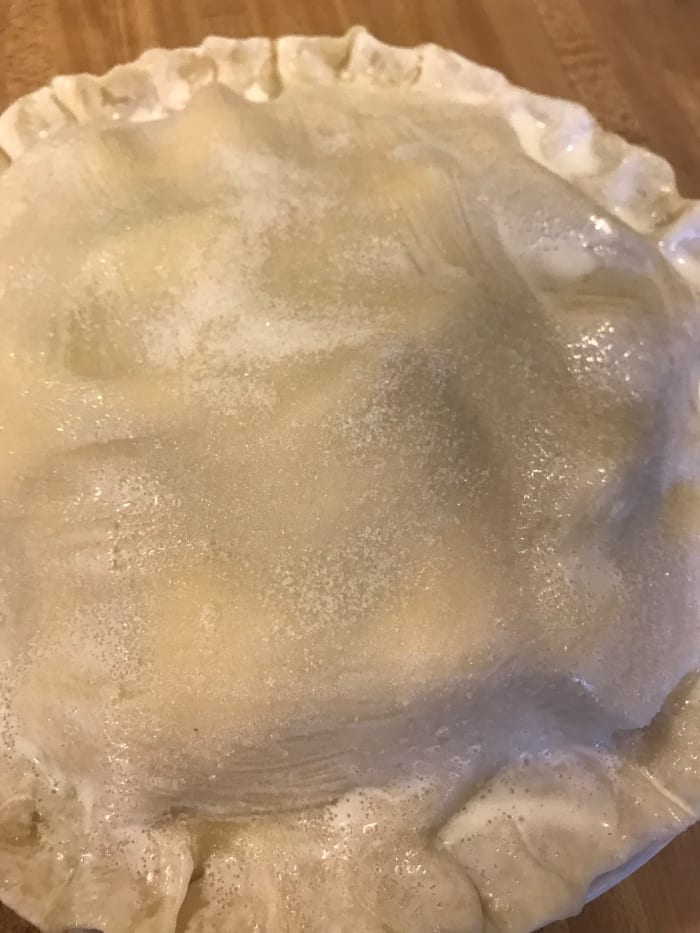 The sugar on the crust may not completely melt - who cares? It will be a little sugary crunch against the flaky crust and spiced apples.