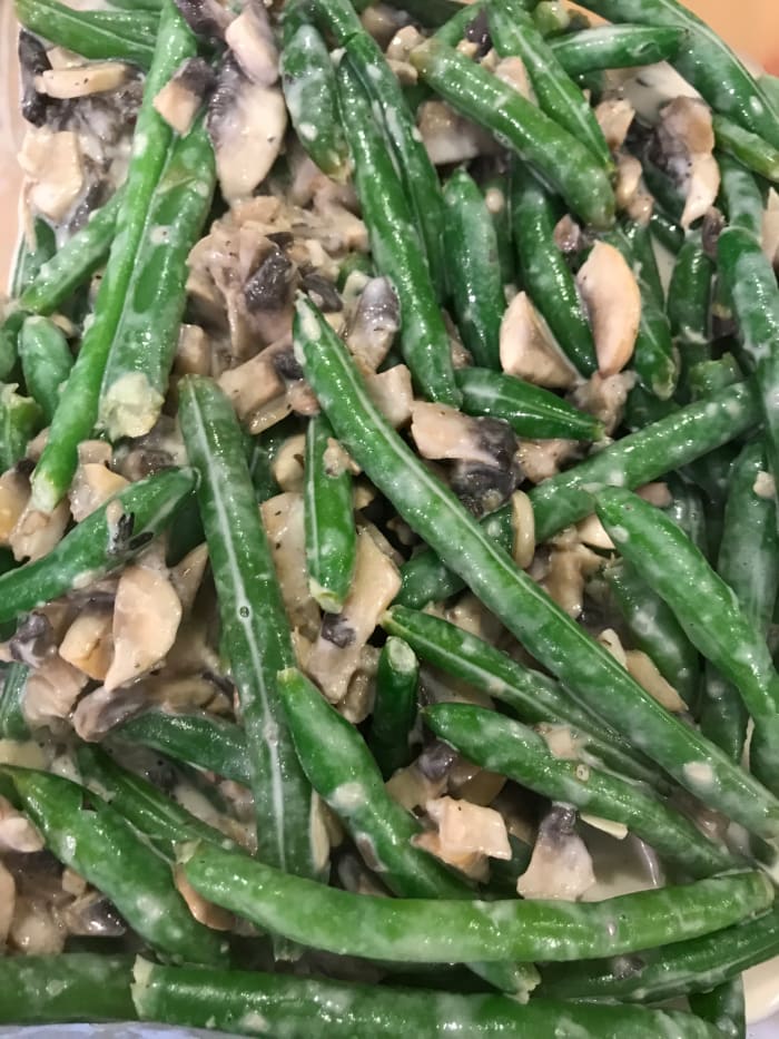 Add the green beans to the sauce and toss to combine. Transfer the whole thing to a casserole dish. Top with crispy onion rings and place in the preheated 350F oven.