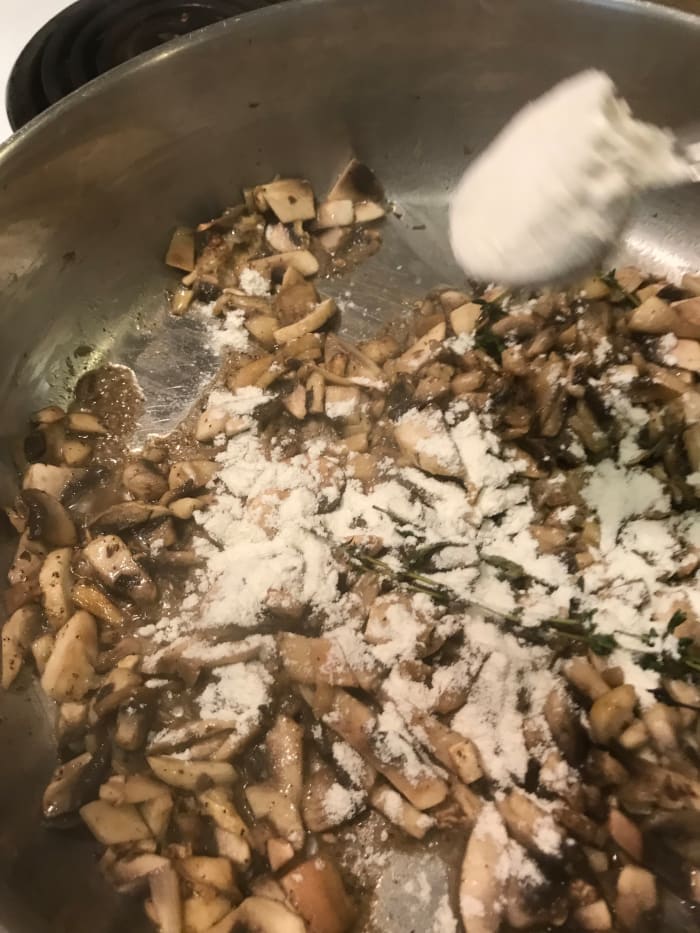 Once the mushrooms release their liquid, sprinkle in the flour. Stir it well, until fully incorporated. Stir in the chicken broth and half and half.