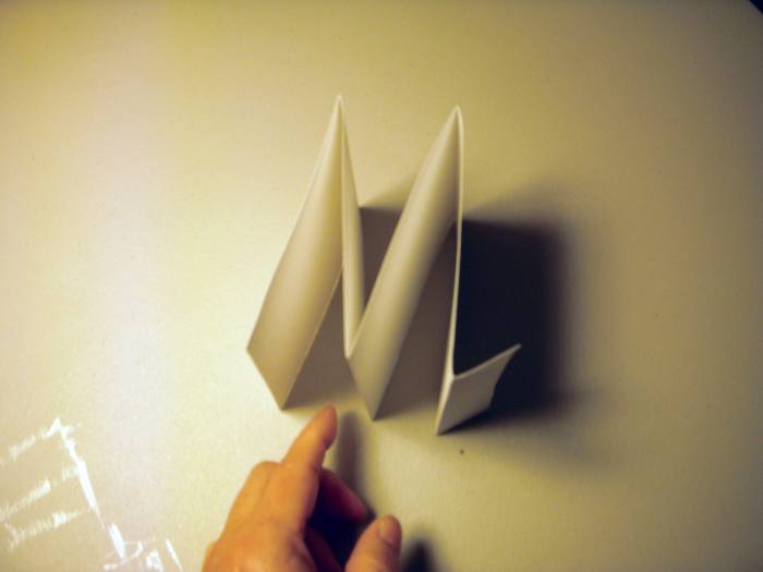 This is what the strip of paper will look like after it is folded. Note the short tab at one end.