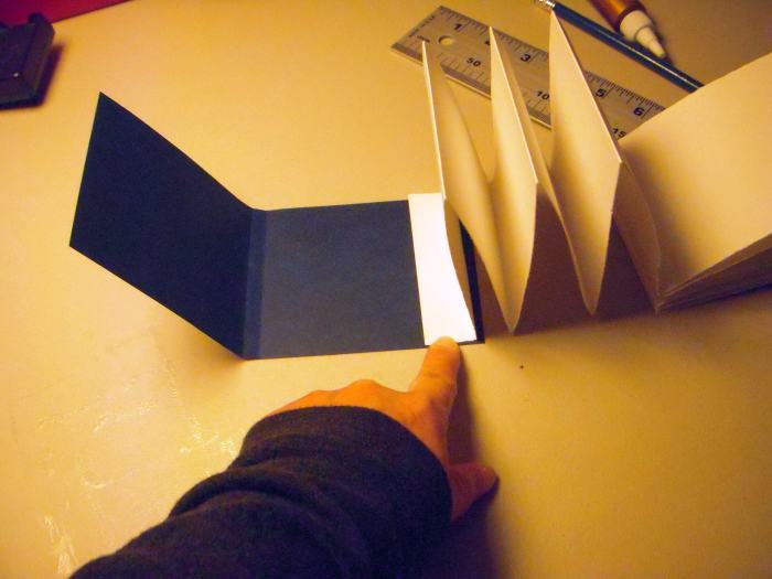 You can attach the pages to the cover close to the open edge of the book. (Note: the picture shows the pages without the back page attached for clarity.)