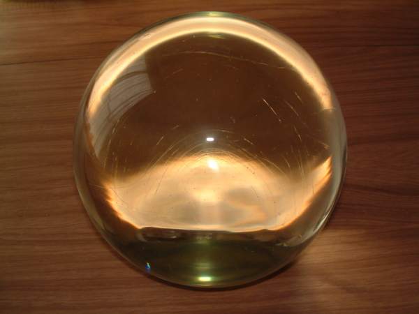 See those thin lines inside the ball that showed up from the camera flash? That's one key sign a crystal ball is glass and not quartz. Another sign is tiny bubbles.