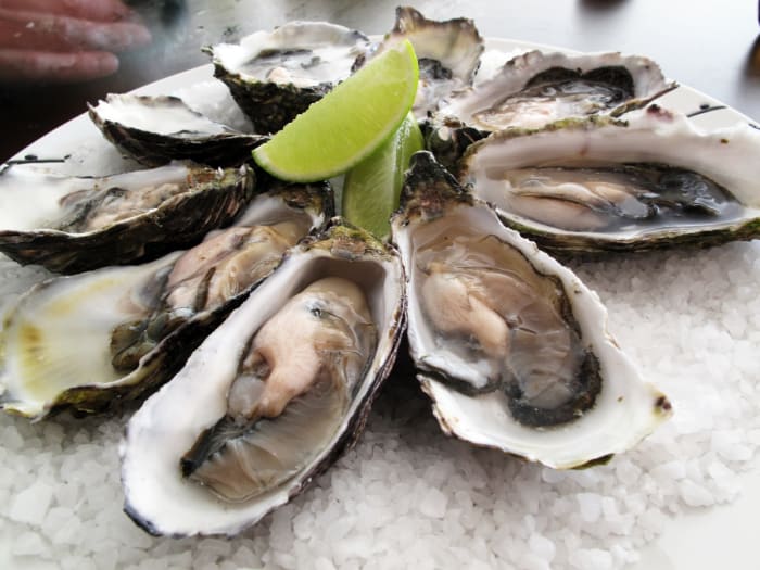 Pacific oysters on rock salt, with lime