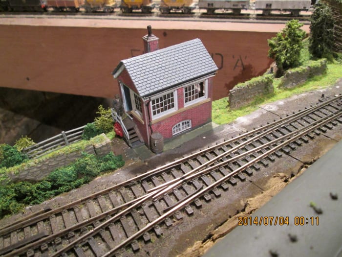 The small 'Ayton Lane mpd' signal cabin on THORALDBY. Peco 'Streamline' and 'Setrack' Nickel silver Code 100 track Etched brass levers, white metal instrument shelf and other details, brass window etches, plastic amchair and desk, white metal figures