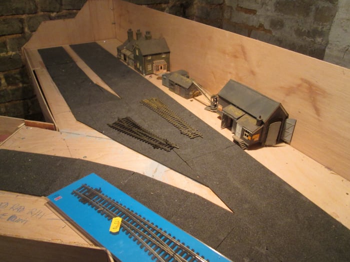 The furthest reaches of Unit 6, with foam underlay (from Carrs) where track is to be laid. Platform and structure edges will be based on the foam. Buildings 'recycled' from the ;Kirkrigg' layout.