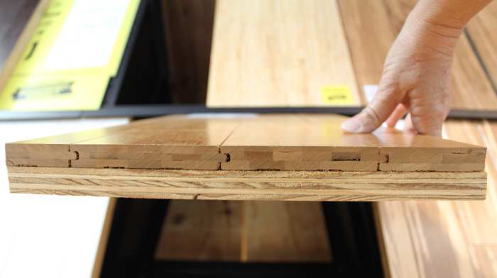 This is the edge of a flooring sample of solid horizontal bamboo mounted on a piece of plywood. Notice how the bamboo planks are 3-ply.