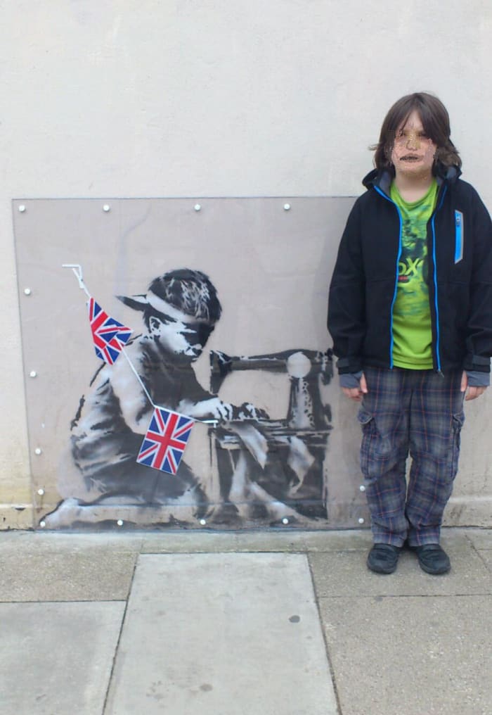 This was painted on the side of a cut-price superstore to underline the fact that we buy cheap clothes sourced from factories abroad that use child labour