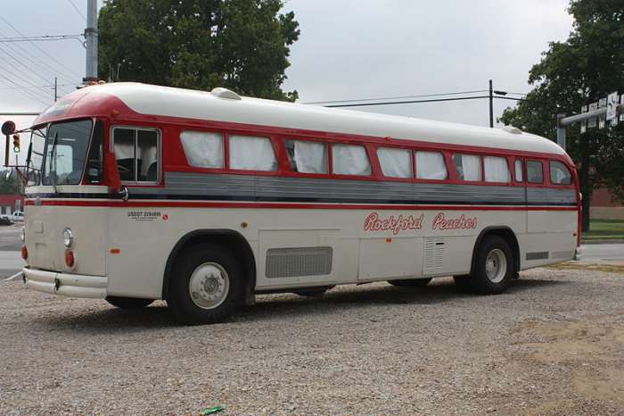 A modern bus with an art design commemorating the Rockford Peaches team.