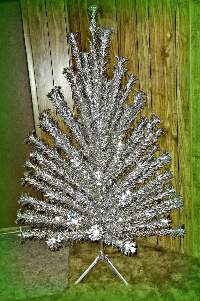 Vintage 6 foot Evergleam Aluminum Christmas Tree with 93 branches complete in sleeves with tripod stand,box, and original instructions.