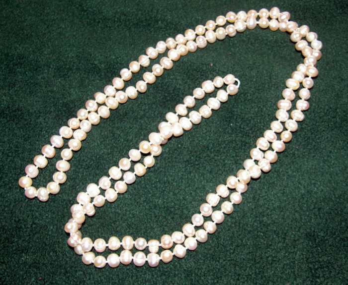 Rope necklace of cream pearls each pearl measuring roughly 11-12 mm...total length of 4 feet